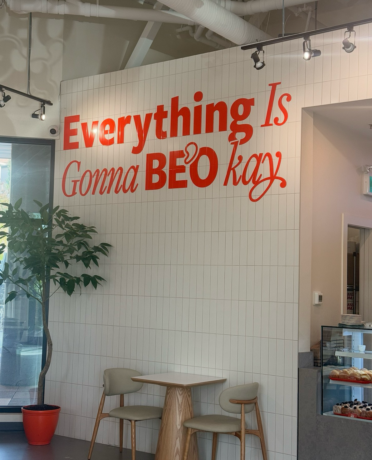 Greedy Donut café — the &lsquo;Everything Is Gonna BE&rsquo;O kay&rsquo; tiled wall